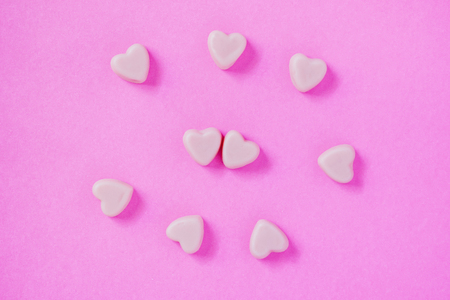 valentine candy hearts shape on pink backgroundの写真素材