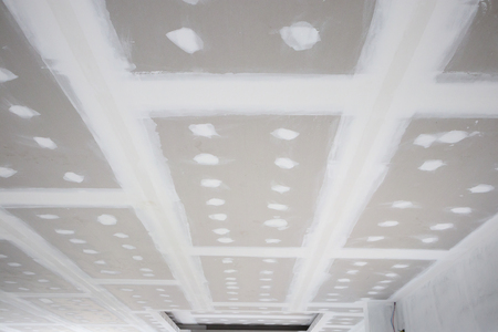 ceiling gypsum board installation at construction siteの写真素材