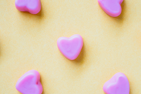 Valentines day background with heart shape candy on yellow backgroundの写真素材
