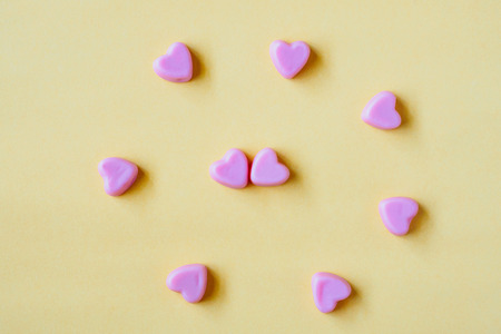 Valentines day background with heart shape candy on yellow backgroundの写真素材