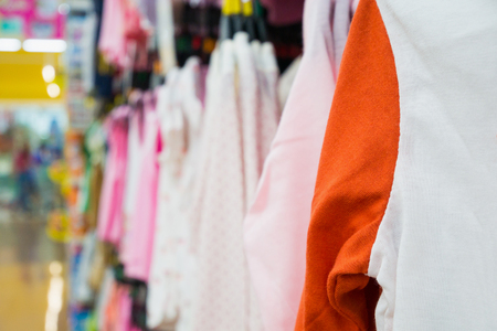 Abstract blurred fashion clothing store in modern shopping mall backgroundの写真素材