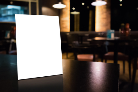 Mockup empty white label menu frame on table with cafe restaurant interior backgroundの写真素材