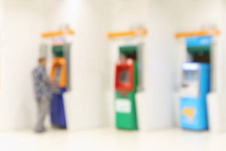 abstract blur man using atm machines for cash withdrawal defocused backgroundの写真素材