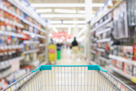 Abstract blur supermarket aisle with hardware and tool background with shopping cartの写真素材