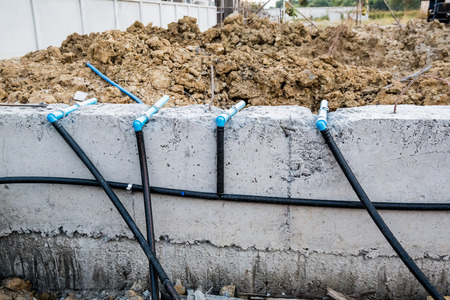 Pest control pipe system install at new house construction foundation for termite protectionの写真素材