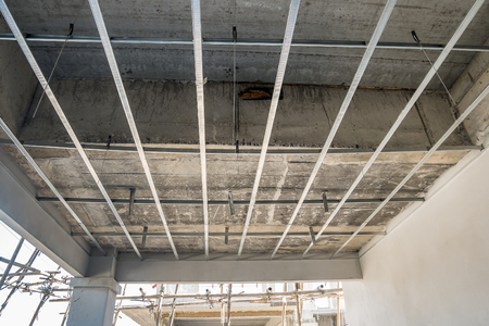Install metal frame for plaster board ceiling at house under constructionの写真素材