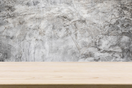 wood table top with cement wall backgroundの写真素材