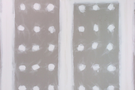ceiling gypsum board installation at construction siteの写真素材