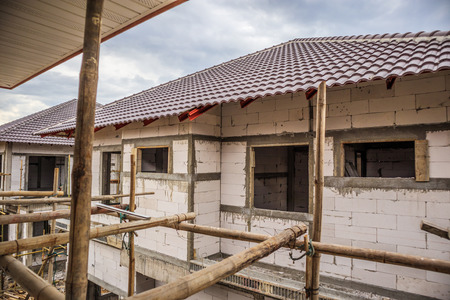 construction residential new house in progress at building siteの写真素材