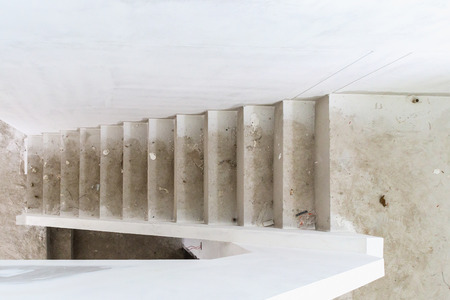 New house construction interior with concrete staircase at building siteの写真素材
