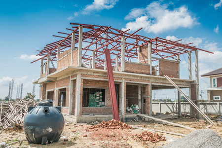 house building structure at construction site with clouds and blue skyの写真素材