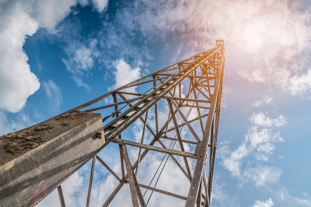 pile driver with clouds and blue skyの写真素材