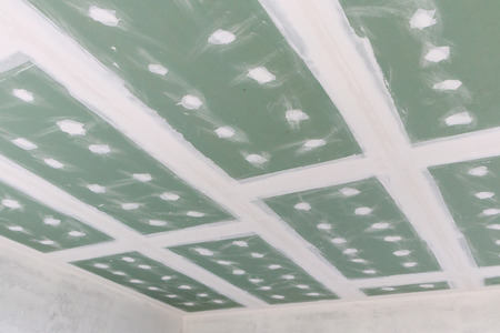 ceiling gypsum board installation at construction siteの写真素材