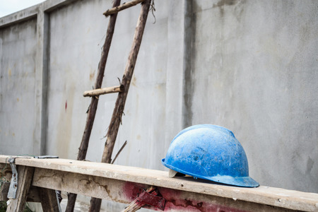 Blue hard hat on house building construction siteの写真素材