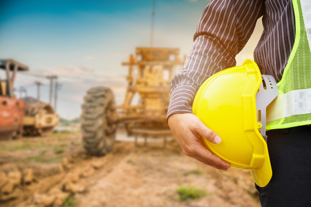 Asian business man construction engineer worker with yellow protective helmet at construction siteの写真素材