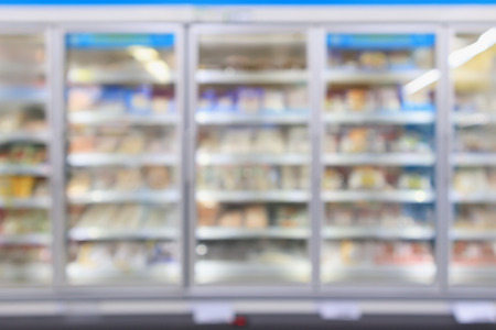 supermarket commercial refrigerators freezer showing frozen foods abstract blur backgroundの写真素材