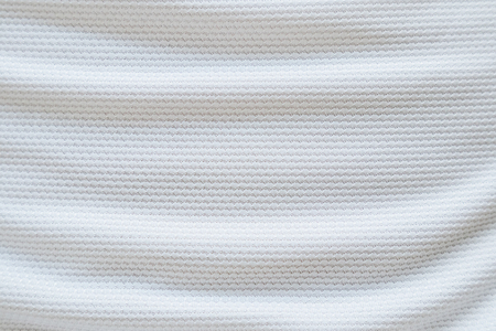 White football jersey clothing fabric texture sports wear background, close upの写真素材