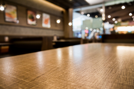 Abstract cafe coffee shoop restaurant table with blur background with bokeh lightの写真素材