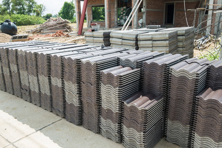 stack of roof tiles for building new house at construction siteの写真素材