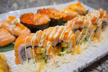 Salmon sushi sashimi and sushi rolls set close upの写真素材