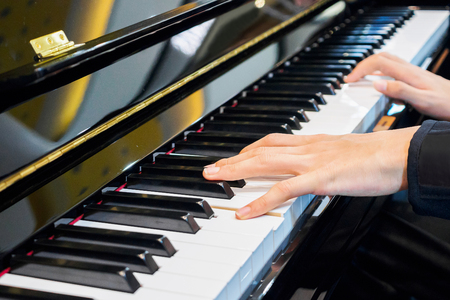 Close up musician hand playing pianoの写真素材