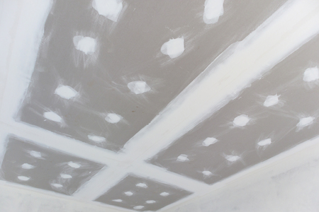 ceiling gypsum board installation at construction siteの写真素材
