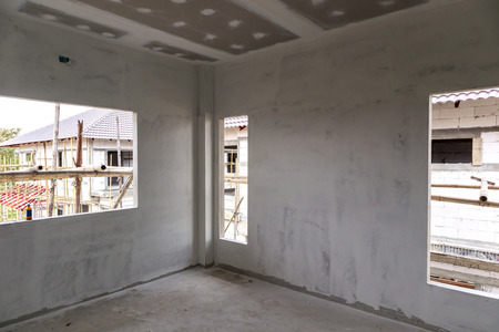 Empty room interior with gypsum board ceiling at house construction siteの写真素材