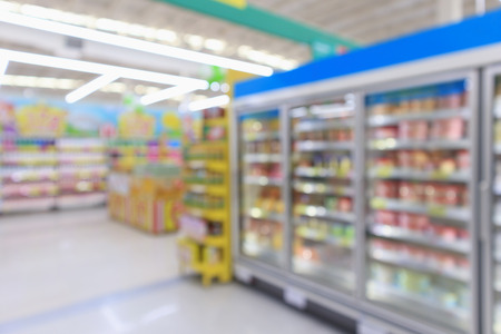supermarket commercial refrigerators freezer showing frozen foods abstract blur backgroundの写真素材