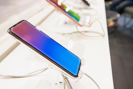 New mobile smartphone show in electronic store, digital gadget for internet and telecommunicationの写真素材