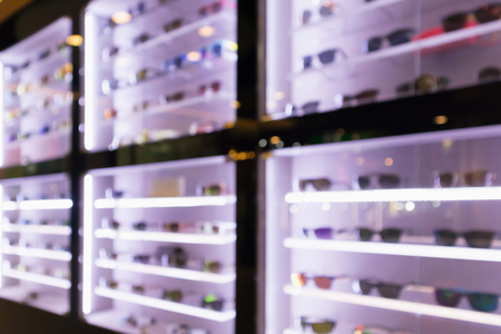 Blur Sunglasses on display shelves in glasses store backgroundの写真素材