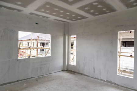 Empty room interior with gypsum board ceiling at house construction siteの写真素材