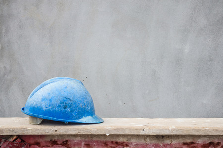 Blue hard hat on house building construction siteの写真素材