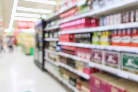 Abstract blur wine liquor bottles on the alcoholic beverage shelves in supermarket storeの写真素材