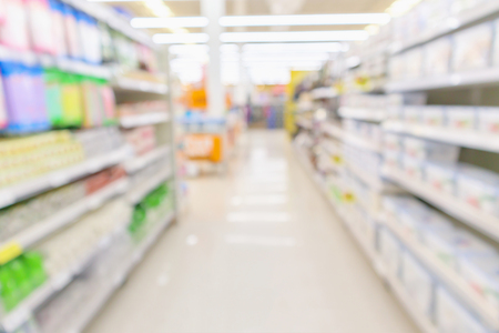 Abstract blur supermarket discount store aisle and product shelves interior defocused backgroundの写真素材