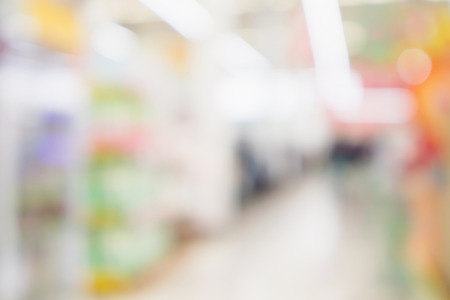 Abstract blur supermarket discount store product shelves interior defocused backgroundの写真素材