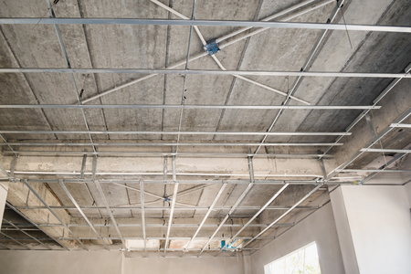 Install metal frame for plaster board ceiling at house under constructionの写真素材