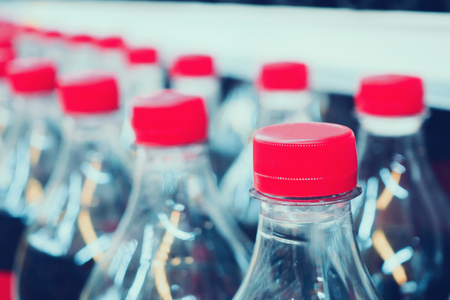 soft drinks bottles on shelves in supermarketの写真素材
