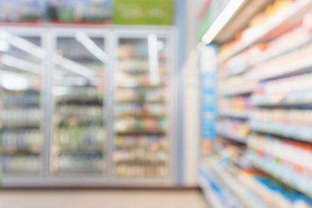 Abstract blur supermarket grocery store refrigerator shelves with fresh milk bottles and dairy productsの写真素材