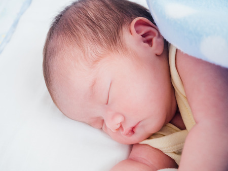 Newborn baby girl sleepingの写真素材
