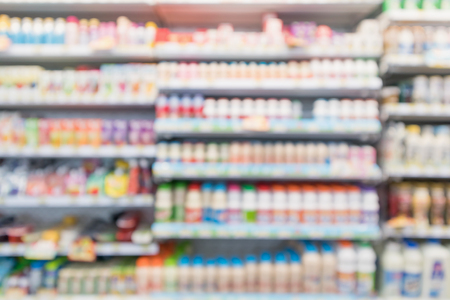 Abstract blur supermarket grocery store refrigerator shelves with fresh milk bottles and dairy productsの写真素材