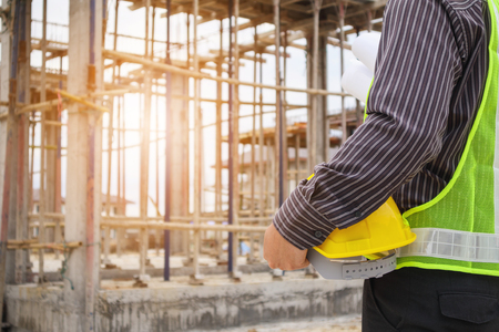 Asian business man construction engineer worker with protective helmet at house building siteの写真素材