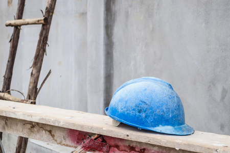 Blue hard hat on house building construction siteの写真素材