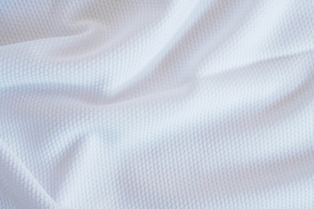 White football jersey clothing fabric texture sports wear background, close upの写真素材