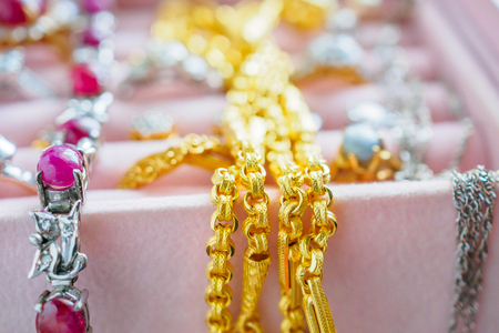 Gold and silver diamond gemstone ring necklaces and earrings in luxury jewelry boxの写真素材