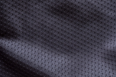 Black fabric sport clothing football jersey with air mesh texture backgroundの写真素材