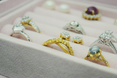 Gold and silver diamond gemstone ring and pearl earrings in luxury jewelry boxの写真素材