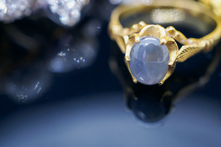 Vintage gold Jewelry blue sapphire rings with reflection on black backgroundの写真素材