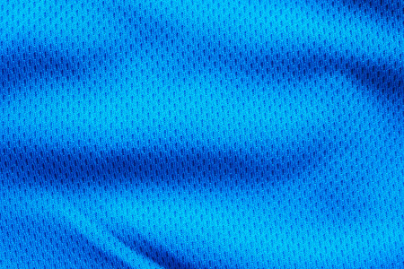 Blue fabric sport clothing football jersey with air mesh texture backgroundの写真素材