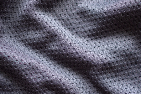 Gray fabric sport clothing football jersey with air mesh texture background