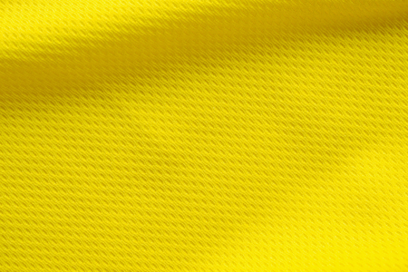 Yellow color football jersey clothing fabric texture sports wear background, close upの写真素材